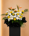 Fallen Petals Condolences Flower Stand with yellow gerberas, sunflowers and bird of paradise, full arrangement