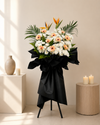 Forever Beyond Condolences Flower Stand with peach gerberas and bird of paradise, front view