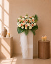 Faith Condolences Flower Stand with champagne gerberas and white paper mums, front view