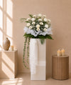 Peace in White Condolences Flower Stand with white gerberas, papermums and baby's breath, front view