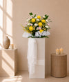 Warm Goodbye Condolences Flower Stand with white gerberas, yellow papermums and pink roses, front view